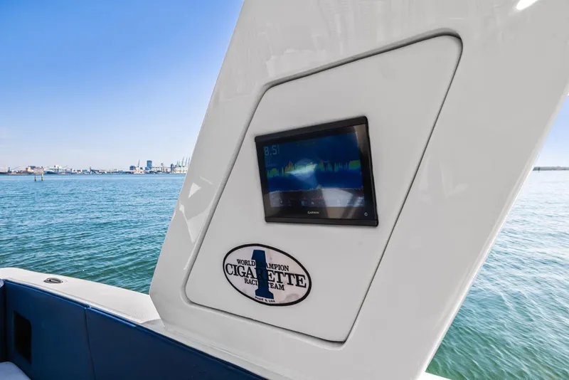 Slide: The Image of 2023 Cigarette 42 Auroris boat with digital display on open water. - 18