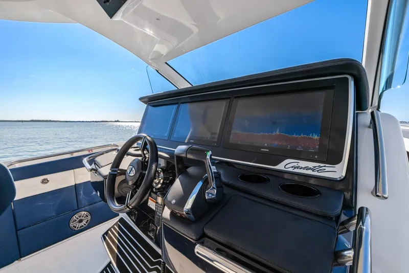 Slide: The Image of Interior view of 2023 Cigarette 42 Auroris boat cockpit with modern controls and steering wheel. - 20
