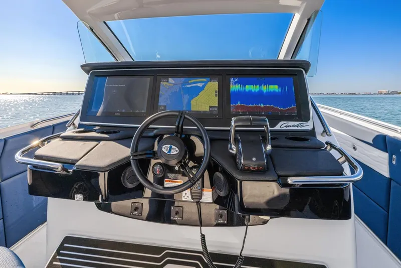 Slide: The Image of 2023 Cigarette 42 Auroris boat dashboard with advanced navigation screens and controls. - 22