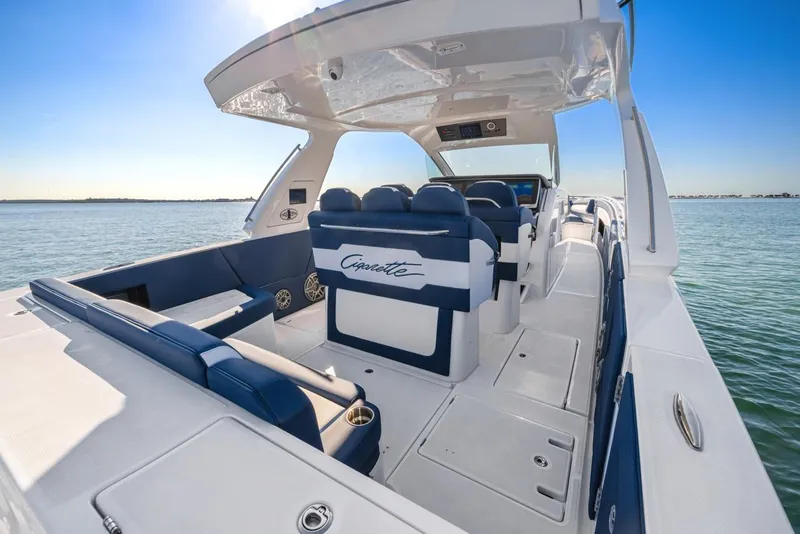 Slide: The Image of 2023 Cigarette 42 Auroris luxury boat interior with blue and white seating on open water. - 23