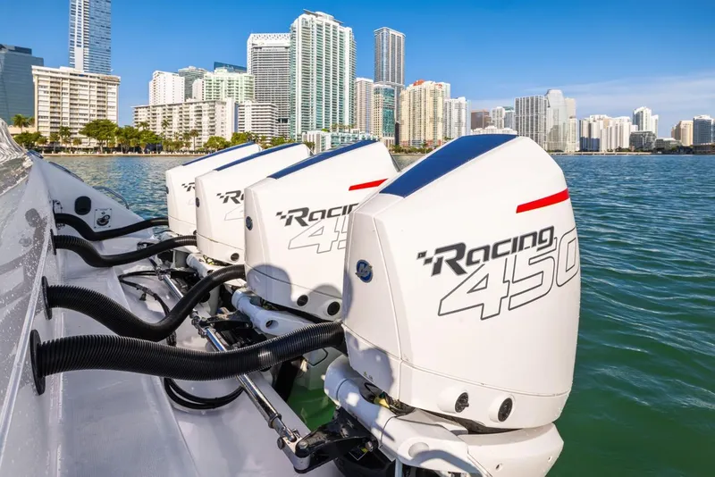 Slide: The Image of 2023 Cigarette 42 Auroris boat with powerful Racing 450 engines, city skyline in background. - 24