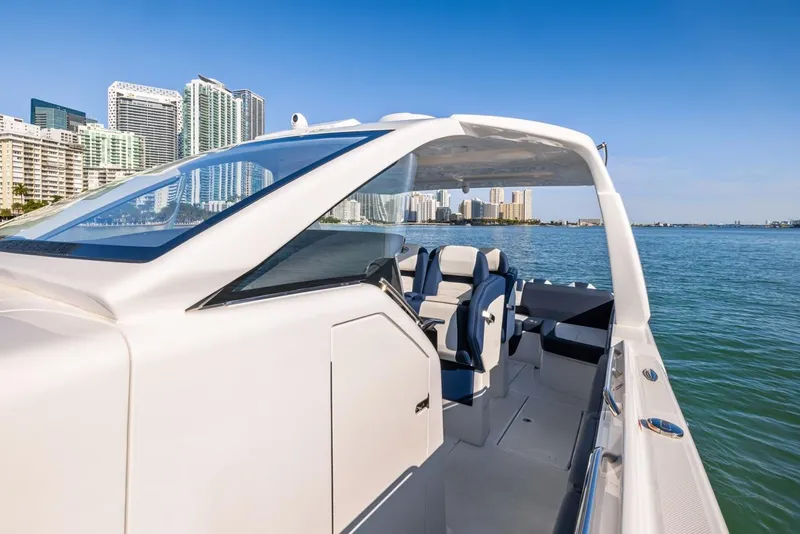 Slide: The Image of 2023 Cigarette 42 Auroris luxury boat on water with city skyline in background. - 28