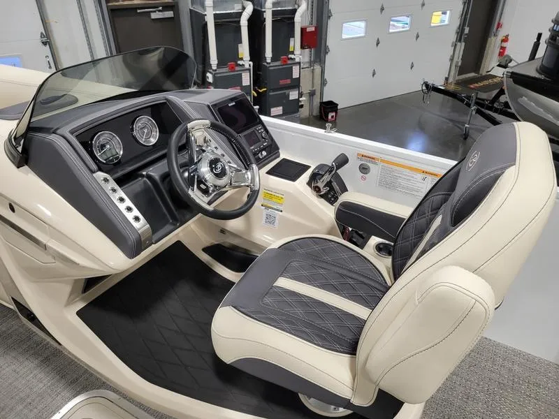 Slide: The Image of 2024 Barletta LEGGERA R26UCA boat cockpit with modern steering and dashboard controls. - 12