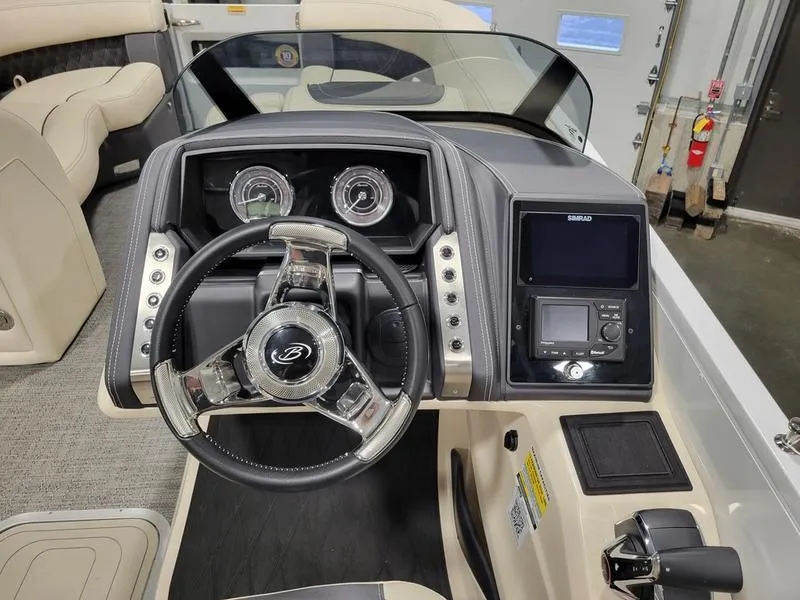 Slide: The Image of 2024 Barletta LEGGERA R26UCA boat dashboard with steering wheel and control panel. - 13