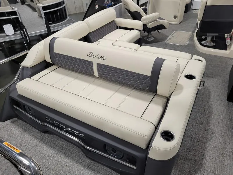 Slide: The Image of 2024 Barletta LEGGERA R26UCA boat interior with luxurious seating and cup holders. - 14