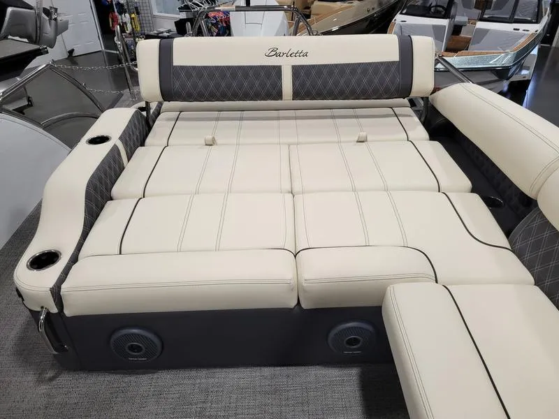 Slide: The Image of 2024 Barletta LEGGERA R26UCA boat interior with luxurious seating and cup holders. - 16
