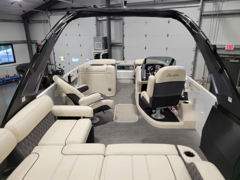 Slide: The Image of 2024 Barletta LEGGERA R26UCA boat interior with luxurious seating and modern helm. - 17