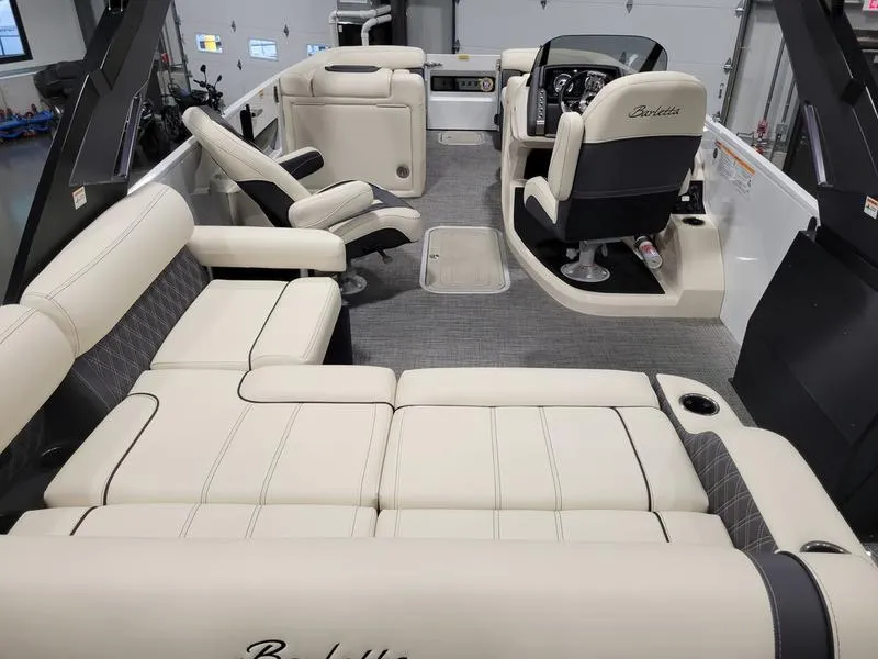 Slide: The Image of 2024 Barletta LEGGERA R26UCA boat interior with luxurious seating and modern dashboard. - 19