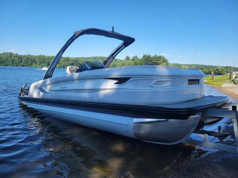 Slide: The Image of 2024 Barletta LEGGERA R26UCA pontoon boat on a lake shore. - 26