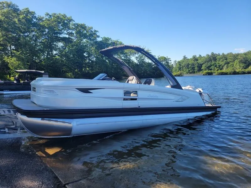 Slide: The Image of 2024 Barletta LEGGERA R26UCA pontoon boat docked on a serene lake. - 3