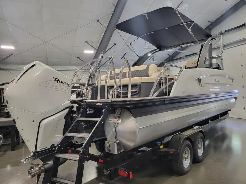 Slide: The Image of 2024 Barletta LEGGERA R26UCA pontoon boat with powerful engine on trailer. - 7