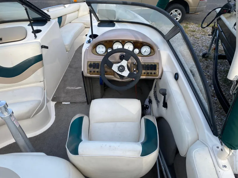 Slide: The Image of 2001 Tigé 211 boat interior with steering wheel and dashboard controls. - 4