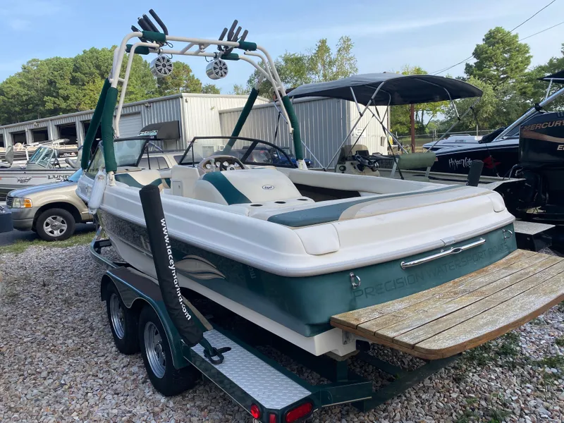 Slide: The Image of 2001 Tigé 211 boat on trailer, green and white, parked outdoors. - 6