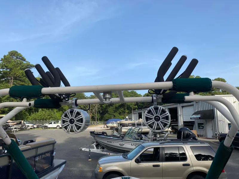 Slide: The Image of 2001 Tigé 211 boat with wakeboard tower and speakers in a marina setting. - 7