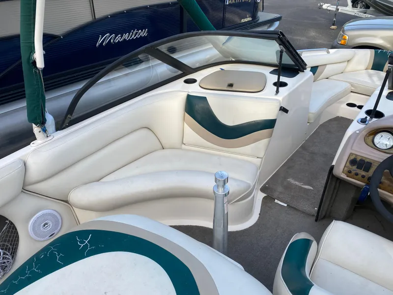 Slide: The Image of 2001 Tigé 211 boat interior with white and teal seating. - 8