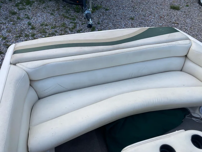 Slide: The Image of 2001 Tigé 211 boat interior with white and green cushioned seating. - 9