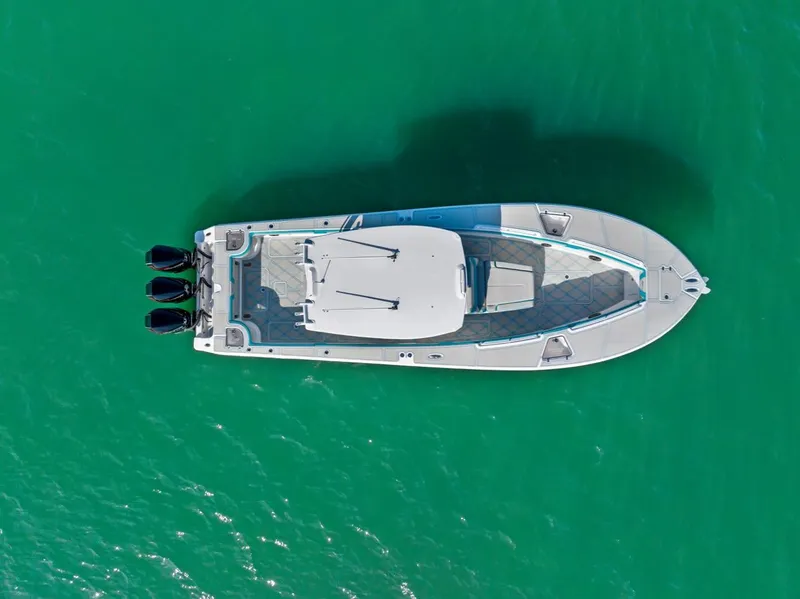 Slide: The Image of Aerial view of 2025 Streamline 35 CC boat on turquoise water. - 10