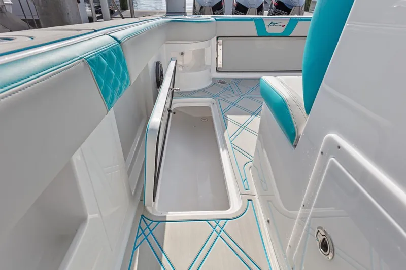 Slide: The Image of 2025 Streamline 35 CC boat interior with open storage compartment and teal accents. - 11