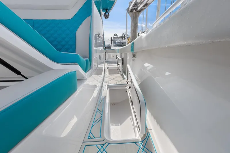 Slide: The Image of 2025 Streamline 35 CC boat interior with teal accents and storage compartments. - 12