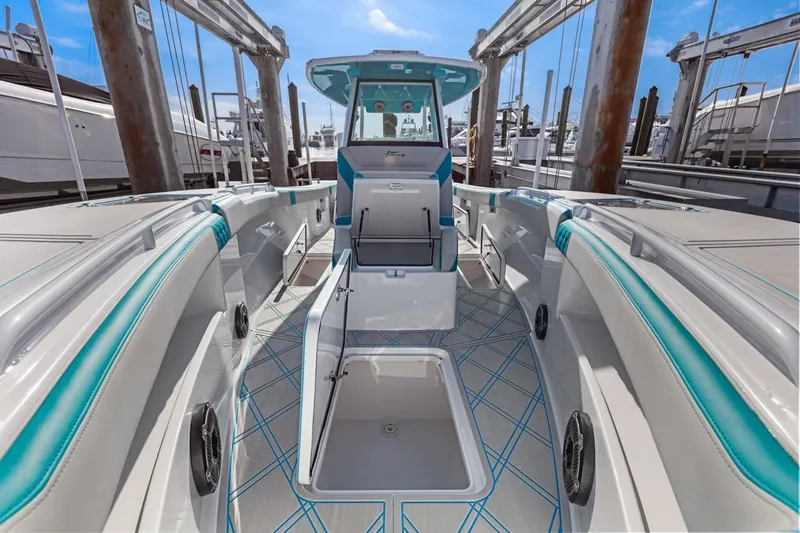 Slide: The Image of 2025 Streamline 35 CC boat interior with open storage compartments at dock. - 13
