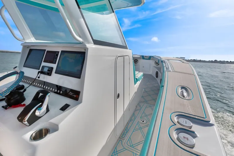 Slide: The Image of 2025 Streamline 35 CC boat dashboard with modern controls on open water. - 14