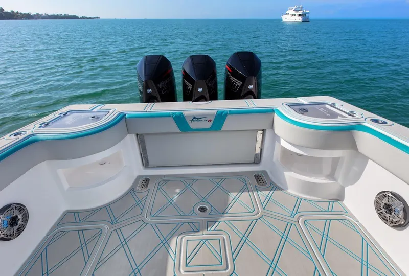 Slide: The Image of Streamline 35 CC 2025 boat deck with triple engines on open water. - 16