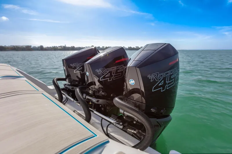 Slide: The Image of 2025 Streamline 35 CC boat with triple outboard engines on the water. - 17