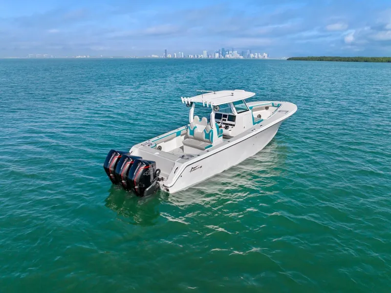 Slide: The Image of Streamline 35 CC 2025 boat on open water with city skyline in background. - 2