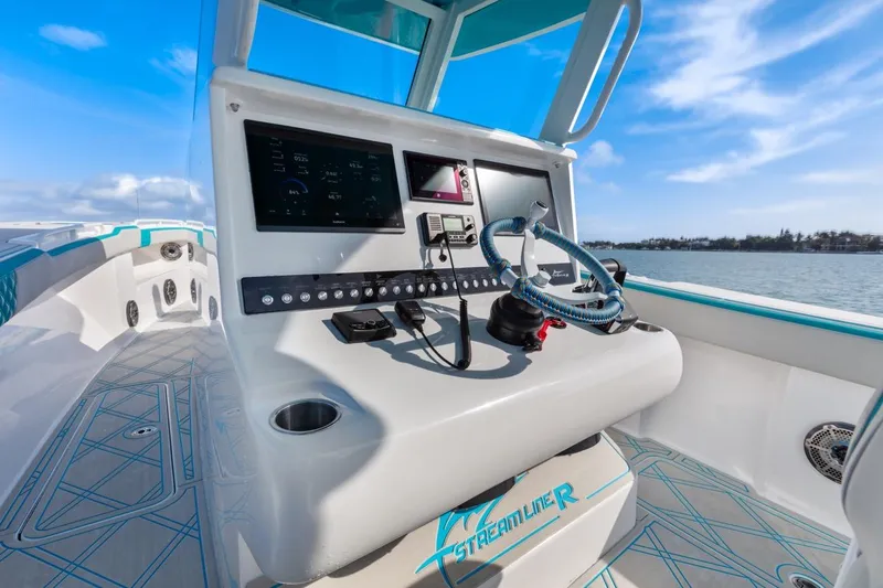 Slide: The Image of 2025 Streamline 35 CC boat dashboard with modern controls and steering wheel. - 21