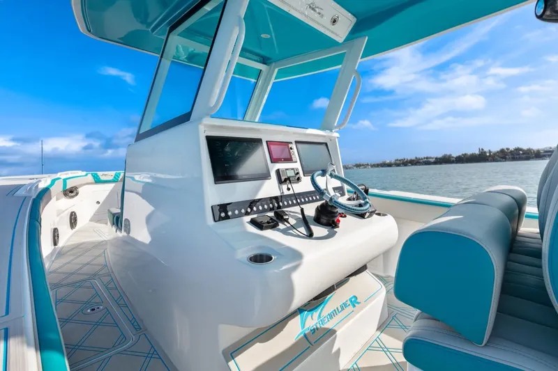 Slide: The Image of 2025 Streamline 35 CC boat interior with modern dashboard and ocean view. - 22