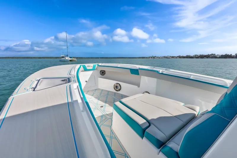 Slide: The Image of Streamline 35 CC 2025 boat interior with seating, on calm blue water. - 25