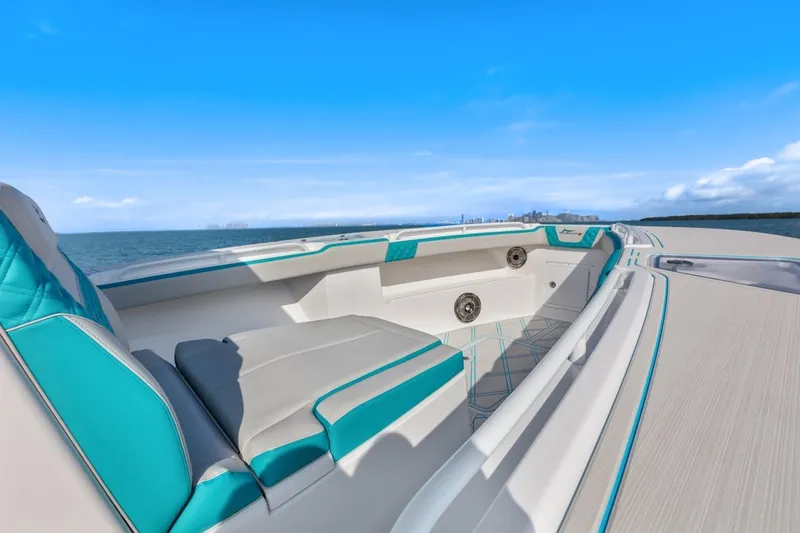 Slide: The Image of Streamline 35 CC 2025 boat interior with teal and gray seating, ocean view. - 27