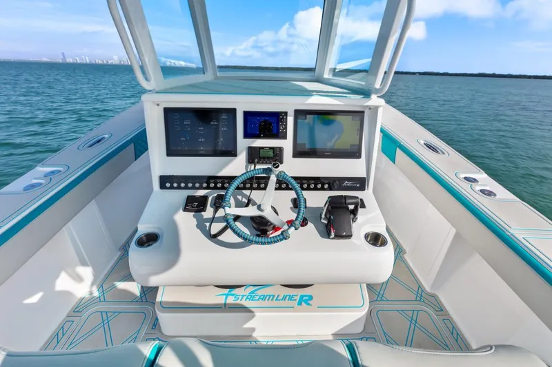 Slide: The Image of Streamline 35 CC 2025 boat dashboard with advanced navigation systems on open water. - 28