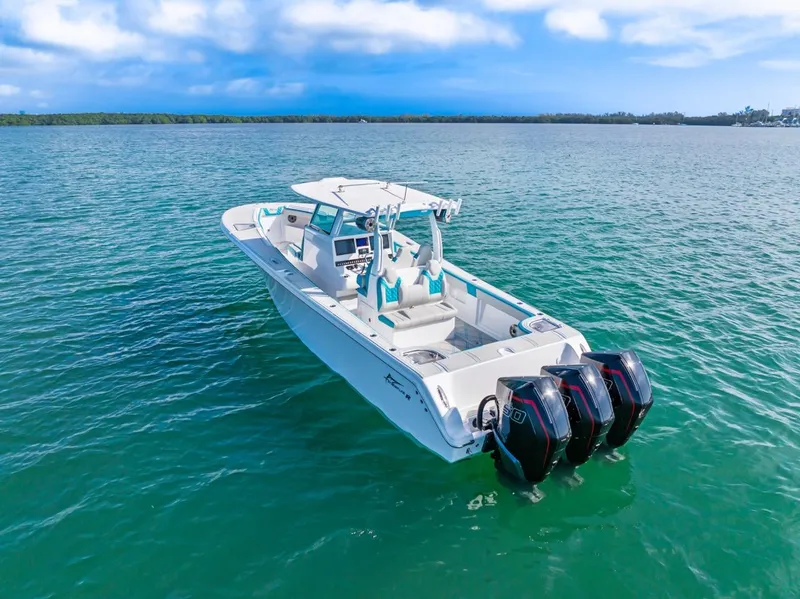 Slide: The Image of 2025 Streamline 35 CC boat with triple engines on calm water. - 3