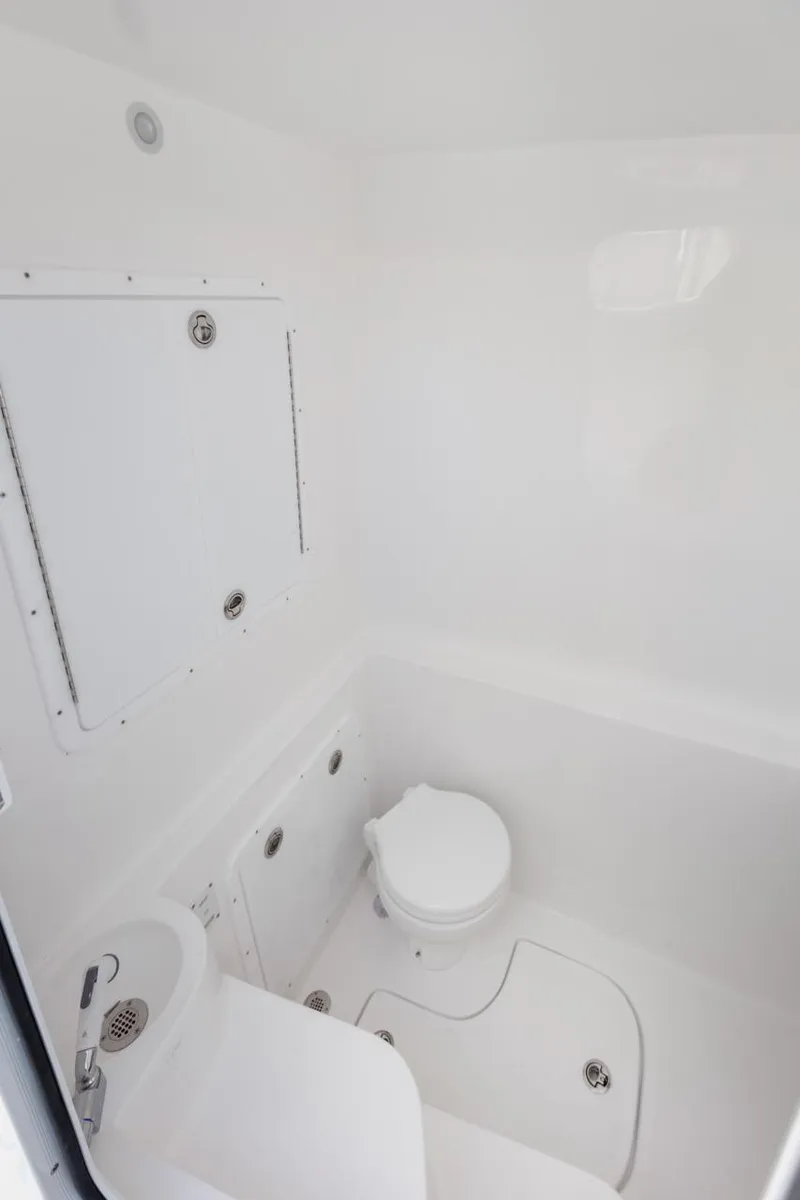 Slide: The Image of 2025 Streamline 35 CC boat bathroom interior, featuring compact white design and modern fixtures. - 30