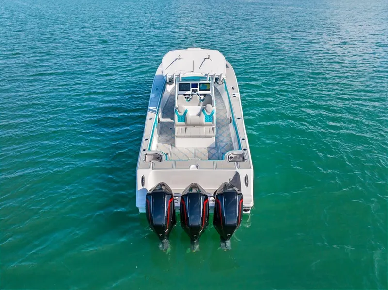 Slide: The Image of 2025 Streamline 35 CC boat with triple engines on clear blue water. - 5