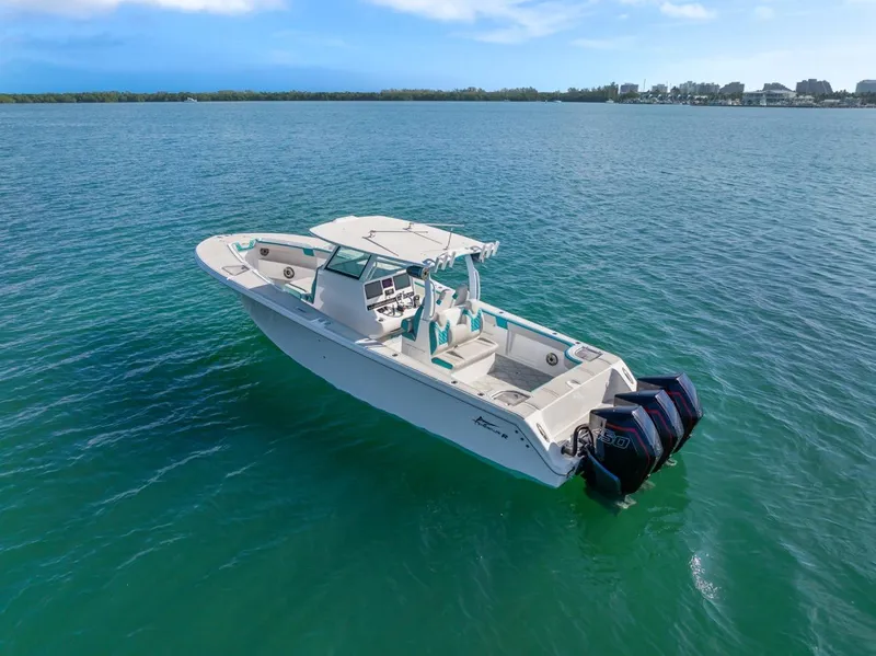 Slide: The Image of 2025 Streamline 35 CC boat on open water, featuring twin outboard engines. - 8