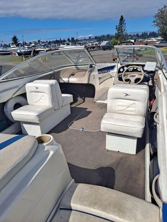 Slide: The Image of 2003 Bayliner 205 Olympic Edition boat interior with white seating and steering wheel. - 10