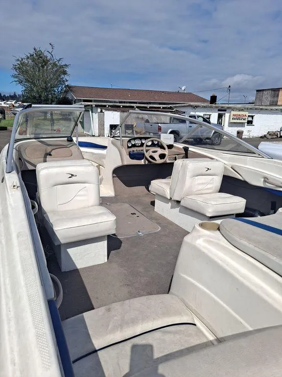 Slide: The Image of 2003 Bayliner 205 Olympic Edition boat interior with seating and steering wheel. - 11