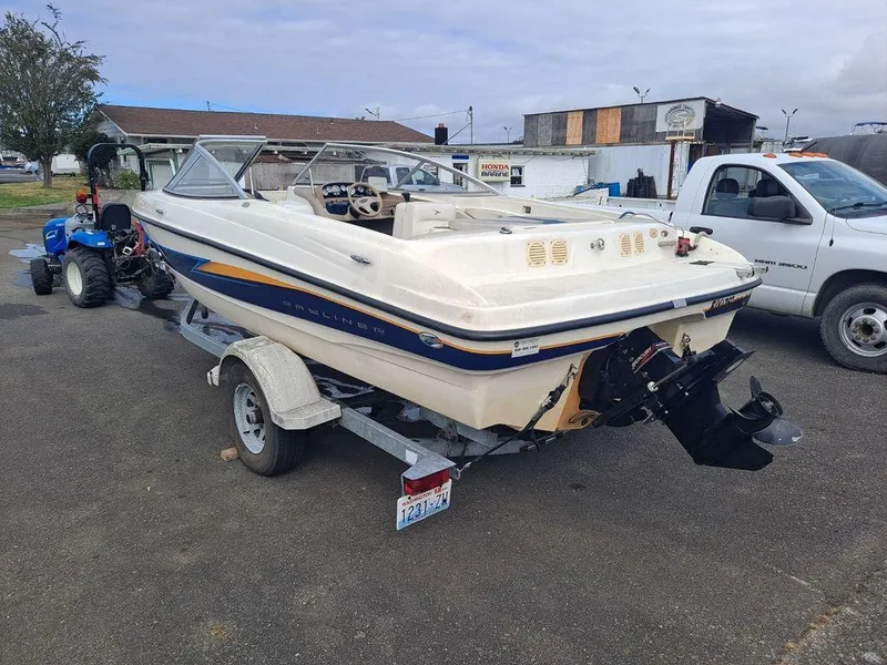 Slide: The Image of 2003 Bayliner 205 Olympic Edition boat on trailer in parking lot. - 3