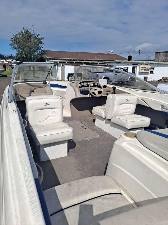 Slide: The Image of 2003 Bayliner 205 Olympic Edition boat interior with seating and steering wheel. - 4