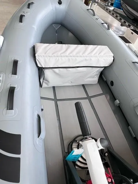Slide: The Image of 2023 Highfield Ultralite 310 inflatable boat interior with seating and motor. - 2