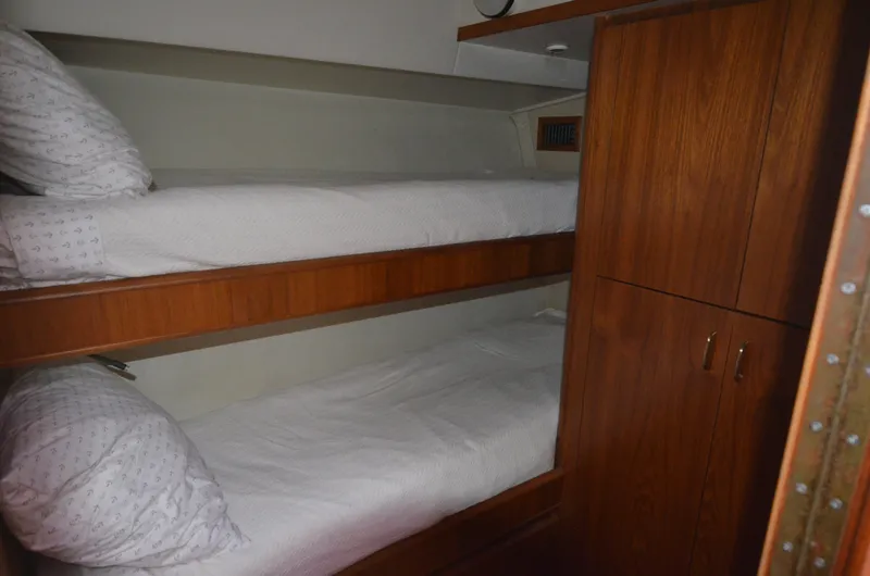 Slide: The Image of Bunk beds in 1993 Tiara Yachts Convertible 430 cabin, featuring wooden cabinetry. - 17