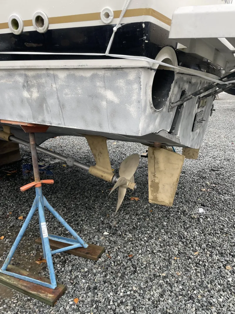 Slide: The Image of 1993 Tiara Yachts Convertible 43, rear view with propeller, on gravel surface. - 22