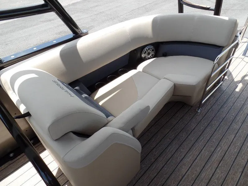 Slide: The Image of 2025 Harris Solstice 270 REC boat interior with beige seating and wood flooring. - 11