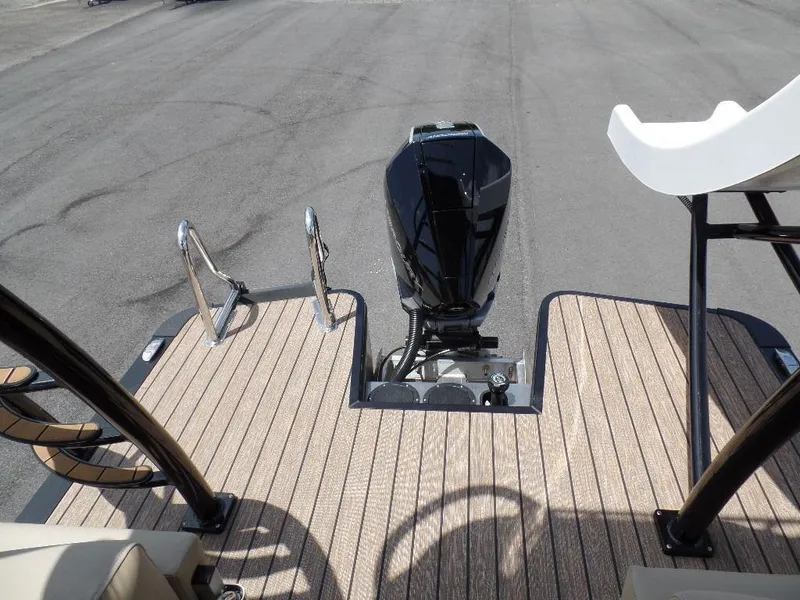 Slide: The Image of 2025 Harris Solstice 270 REC boat with outboard motor and deck view. - 13