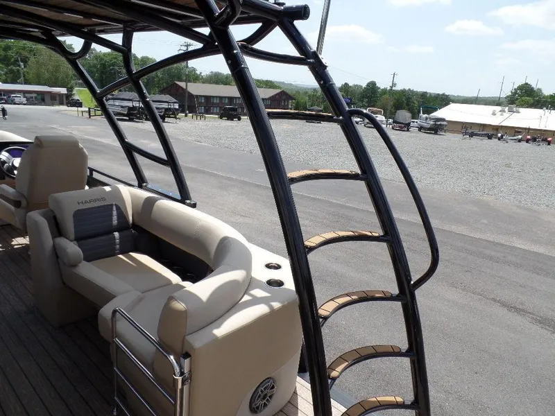 Slide: The Image of 2025 Harris Solstice 270 REC boat with beige seating and sleek black railing. - 17