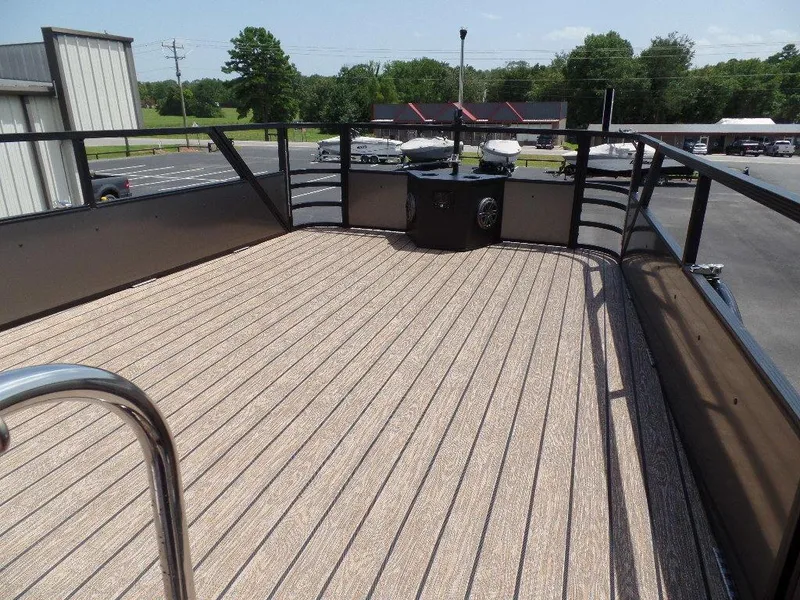 Slide: The Image of 2025 Harris Solstice 270 REC boat deck with railing, parked outdoors. - 20