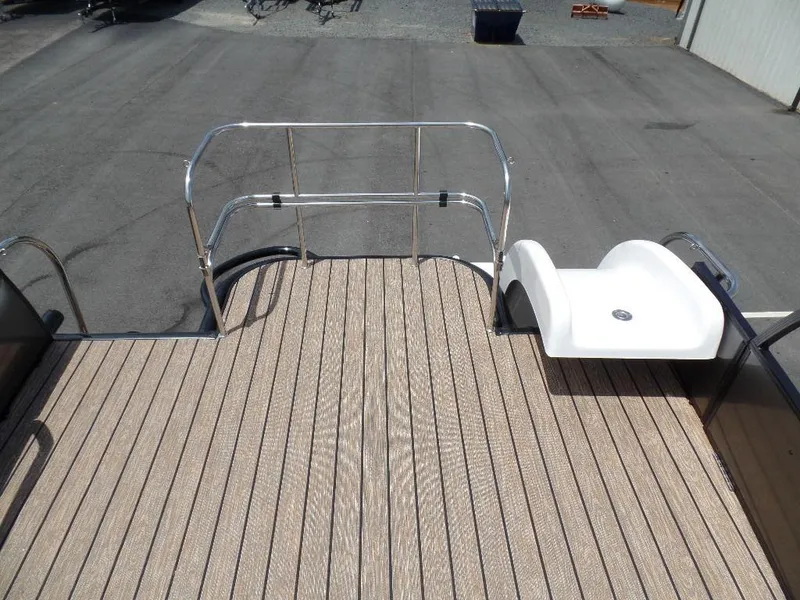 Slide: The Image of 2025 Harris Solstice 270 REC boat deck with sleek railing and swim platform. - 21