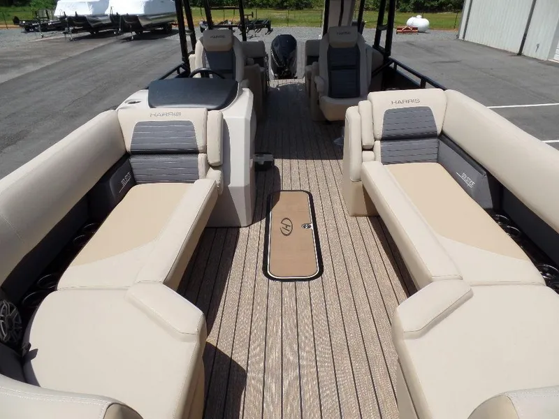 Slide: The Image of 2025 Harris Solstice 270 REC pontoon boat interior with beige seating and spacious layout. - 3